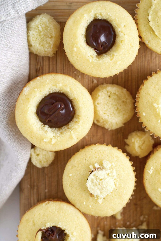 cupcakes with ganache inside on a cutting board