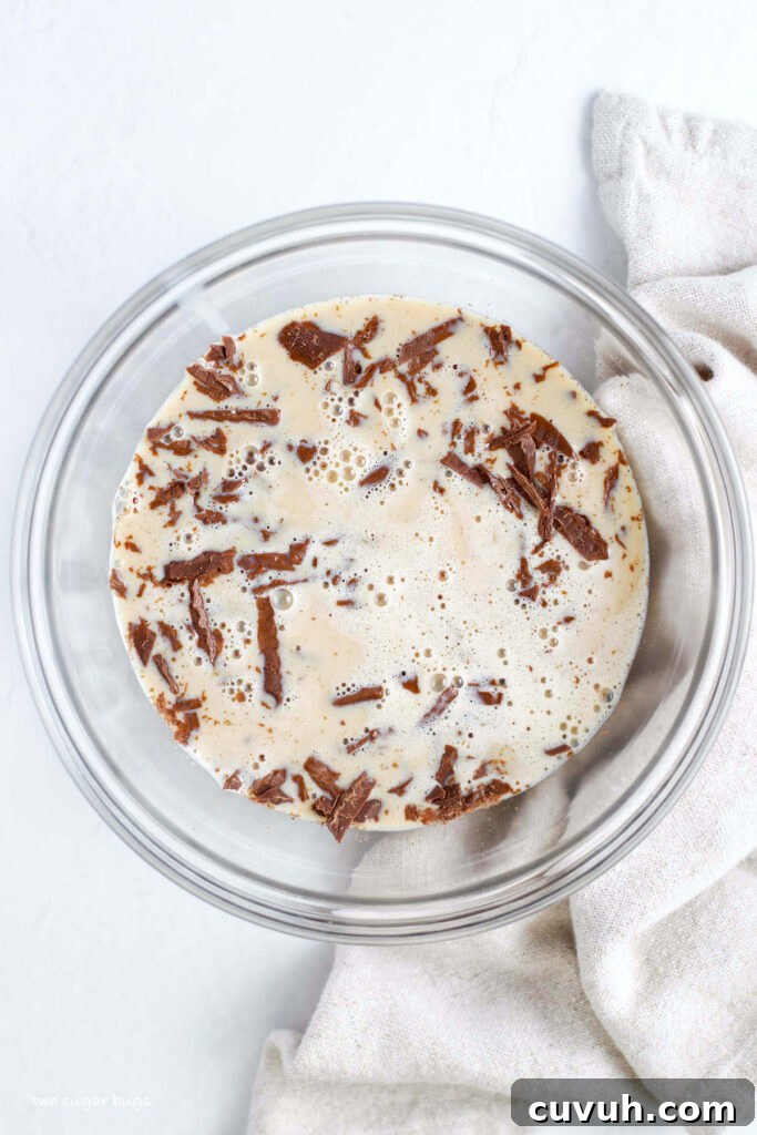irish cream and heavy cream over chopped chocolate
